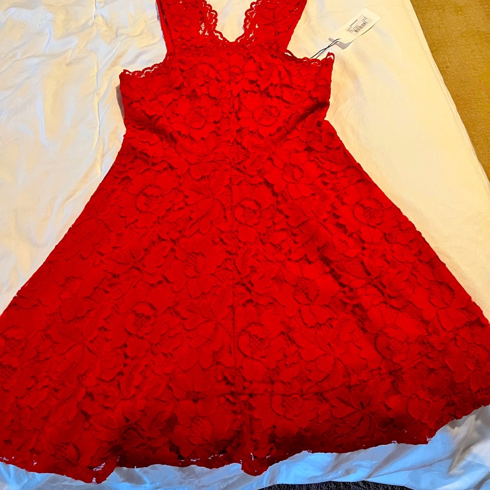Designer red lace cocktail dress from Sandro. NWT. Perfect for holiday parties